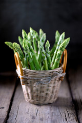 Fresh green organic asparagus on an old wooden background. Healthy food. Copy space. 