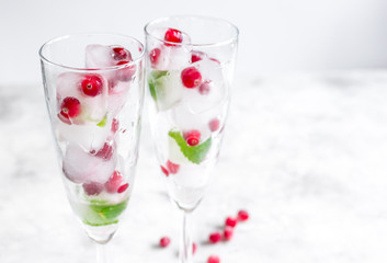 fresh cranberry in ice cubes in glasses on white background mock-up