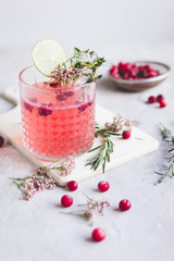 summer homemade juice with lime and berries on stone table background