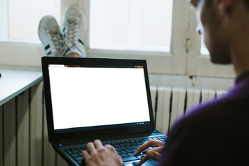 close-up of the young man with the laptop at home working