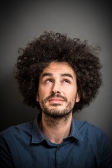 Obraz premium Pondering Young Man with Afro Hair