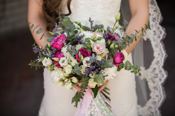 Bride with wedding bouquet of fresh flowers
