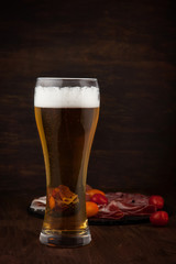 Glass of cold beer with appetizers