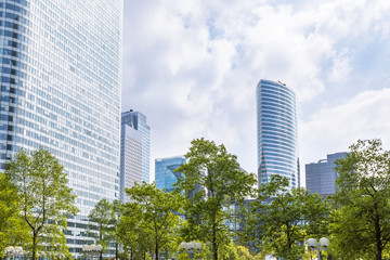 Modern business district with green trees and skyscrapers, Paris