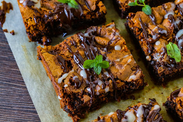 Delicious homemade brownie with dark and white chocolate sauce on the baking sheet.