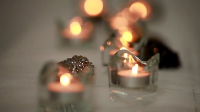 the white candle is lit on a white background
