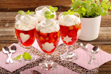 Delicious fruits jelly dessert in a glass with white gelatin shape decorations