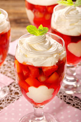 Delicious fruits jelly dessert in a glass with white gelatin shape decorations