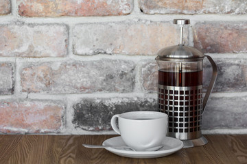 Teapot and a cup of tea on an old wooden table with copy space