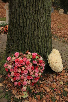 Sympathy flowers near a tree