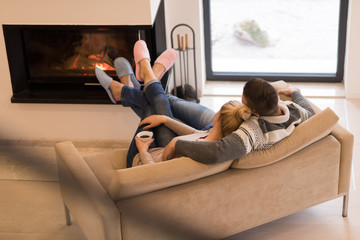Young couple in front of fireplace