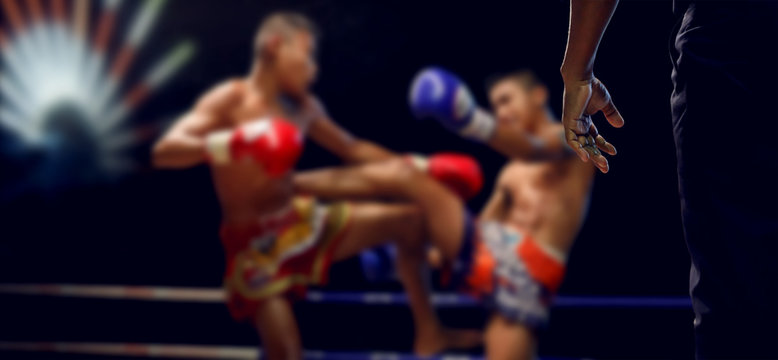 Boxing Referee and blurry of child boxer,Muay Thai.Real shot with night scene. © chokchaipoo