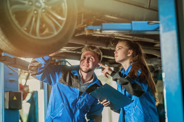 Man and woman in auto mechanics