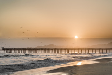Hazy Sunset over Seacliff State Beach. Aptos, Santa Cruz County, California USA. - obrazy, fototapety, plakaty