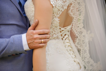 Wedding ring, groom holding bride in white bridal dress. Wedding concept