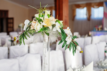 Ornamental flowers on a table in a vase. Concept of holiday and wedding.