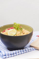 Instant noodles in bowl on wood background