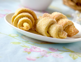 Many croissants on a table with spring flowers