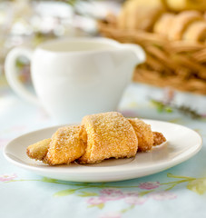 Many croissants on a table with spring flowers