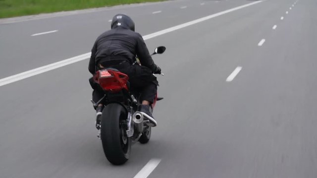 Stuntman Riding His Motorcycle On The Highway Chasing