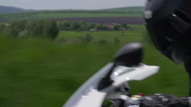 close-up shot of haunted stunt rider driving on highway