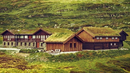 Fototapeta premium Scene with rural home, built in Scandinavian construction design tradition - nature friendly design, house with grass at the roof. Location: Hardangervidda national park, Norway, Scandinavia, Europe.
