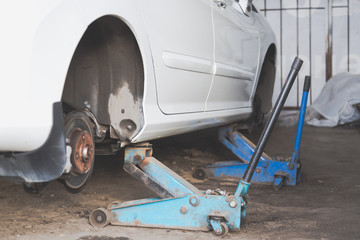 Fototapeta premium Car wheel tire replacement on tire jack