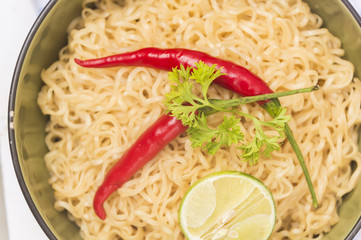 Instant noodles in bowl on wood background