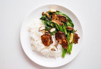 Thai food,Stir fry Chinese kale with pork and cooked rice on dish ready to eating