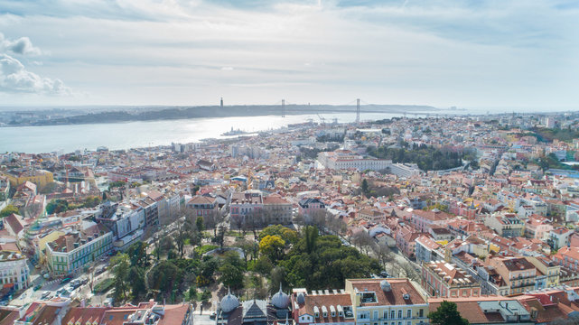 Aerial panoramic view over Lisbon in beautiful sunset sunshine.Saint George castle,downtown and neighbourhood of Alfama,river Tagus in european capital,Lisbon,Portugal.Aerial travel photography

