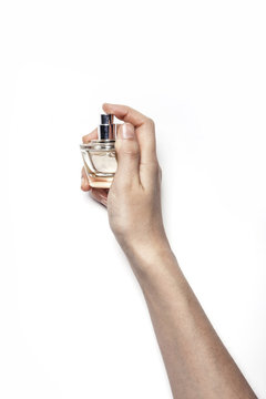 Woman Hand Hold A Perfume Isolated White.