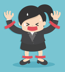 Business woman in suit is taped to the wall with adhesive tape