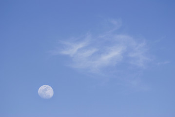 Moon and soft clouds in evening sky