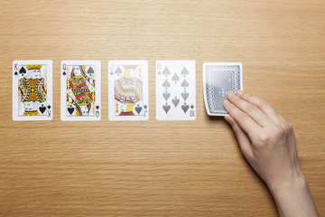 woman hand hold a card on the wood table.