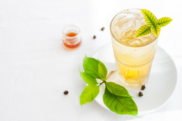 Ice green tea in glass fresh leaves. Copy space.