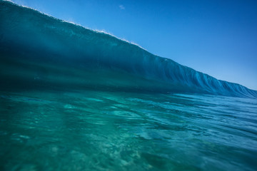 Big ocean wave in pipeline shape rising. Sea water ready to break