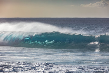 Blue ocean shorebreak wave for surfing sport activity. Template with nobody on background. Tropical summer scenery