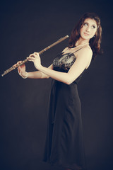 Elegant woman with flute instrument.