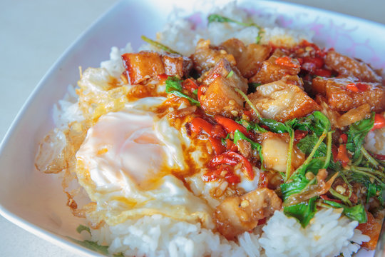 Spicy crispy pork puff with basil and fried egg.