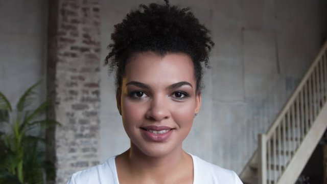 Portrait of attractive smiling African-american woman with make up.