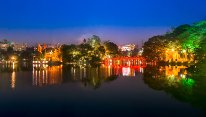 Fototapeta na wymiar Tourists visit Hoan Kiem Lake Public park at night time in Hanoi city. Hoan Kiem Lake has mean 