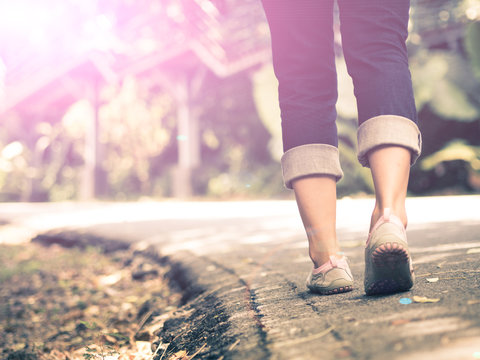 Woman Walking Towards On The Road Side.