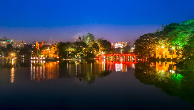 Tourists visit Hoan Kiem Lake Public park at night time in Hanoi city. Hoan Kiem Lake has mean " Lake of the Returned Sword" it one of Famous tourist destination in Vietnam.