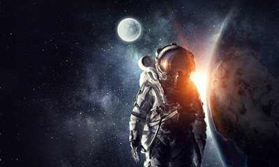Obraz na płótnie Canvas Astronaut in outer space. Mixed media