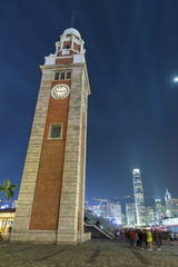Fototapeta premium Clock tower and Skyline of Hong Kong city at night