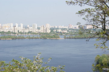 City above the big river, bridge over the river, spring, green trees