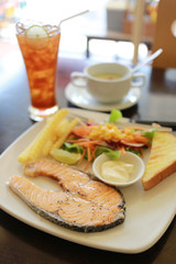 Salmon steak in a white plate.