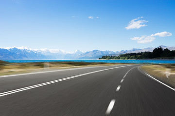 empty road with blue sea in blue sky