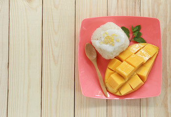 mango and sticky rice on wood background.