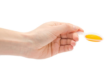 woman hand holding spoon with syrup.